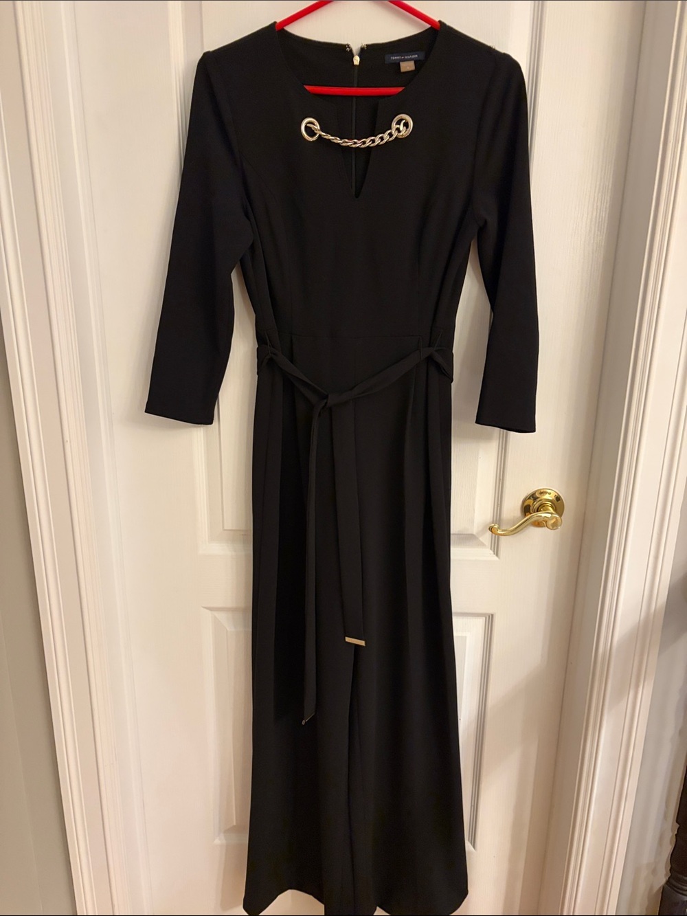 Elegant Black Long-Sleeve Jumpsuit with Gold Chain Detail